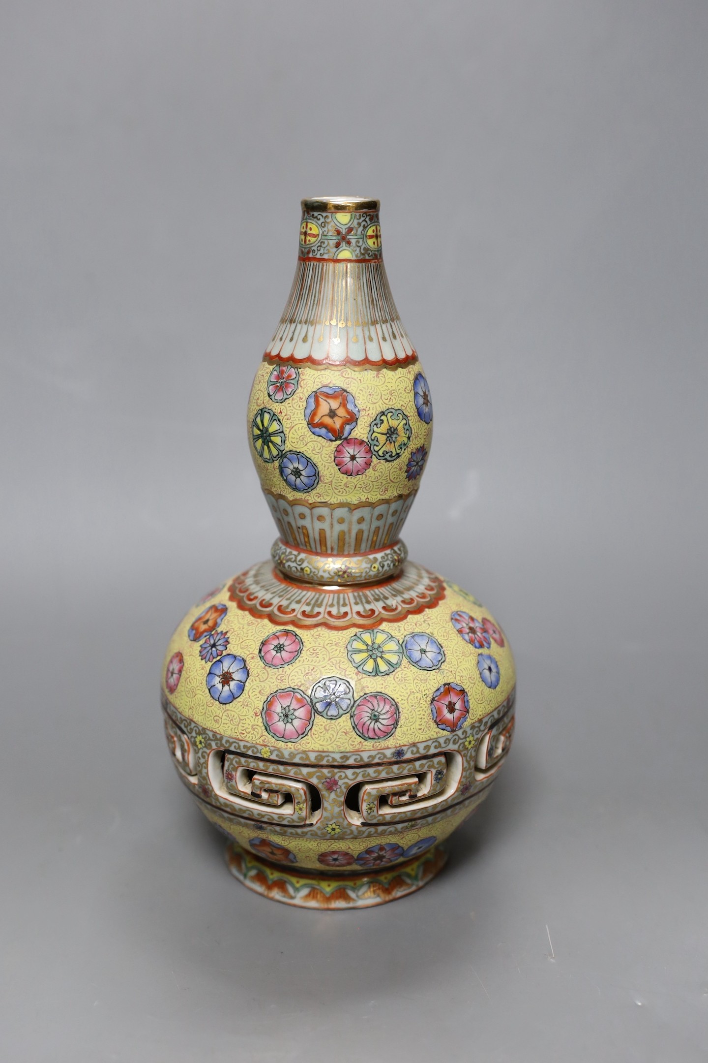 A Chinese enamelled porcelain double walled rotating vase, 24cm